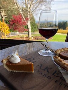 Slice of pumpkin pie with a glass of Blakeslee wine