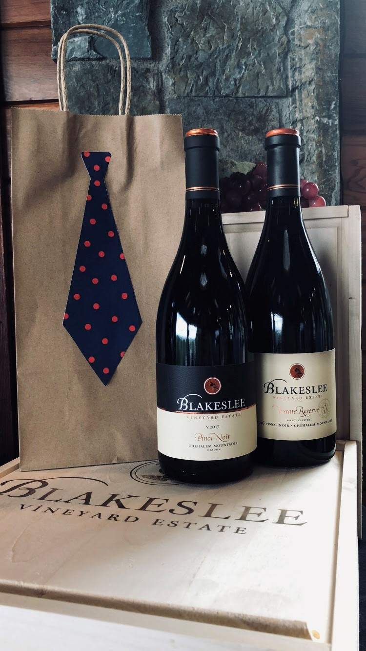 Two bottles of Blakeslee wine in front of a brown bag with a tie